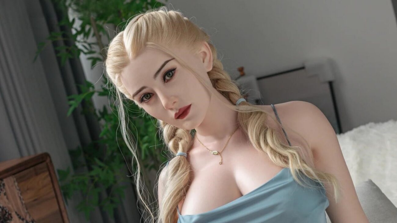 Lifelike Fanreal silicone doll with blonde hair and blue eyes, showcasing realistic features.